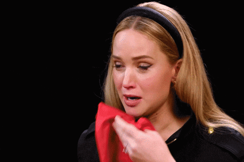 a meme of Jennifer Lawrence on Hot Ones demonstrating my reaction when grown ass adults admitted they haven't cracked a book since high school